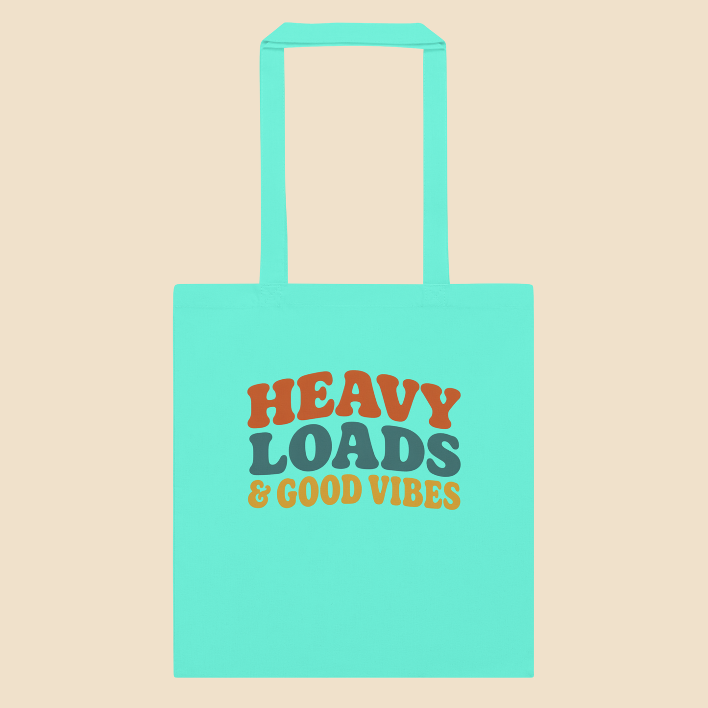 Bolsa de tela tote bag de algodón en color menta con diseño tipográfico retro Heavy Loads and Good Vibes.
