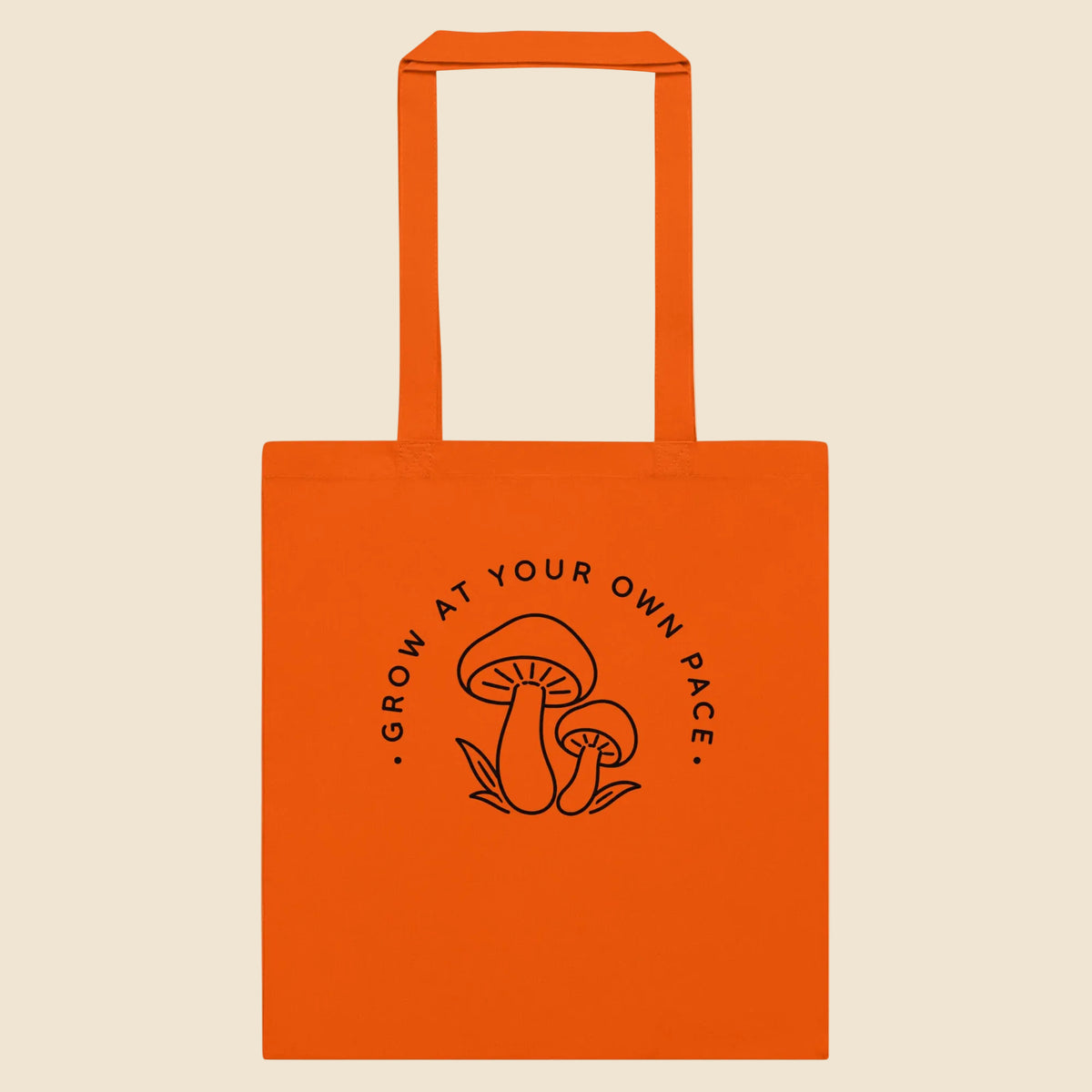 Bolsa de tela clásica en color naranja con ilustración botánica silvestre de estilo line art.
