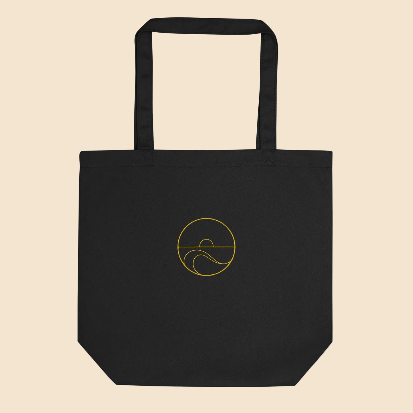 Ecobolsa de algodón orgánico color negro con estampado circular dorado de sol y olas del mar.